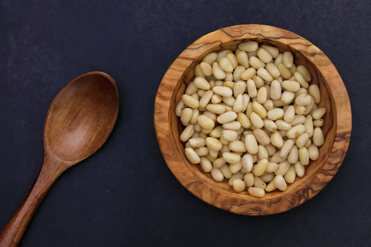 Shelled pine nut kernels in a wooden bowl