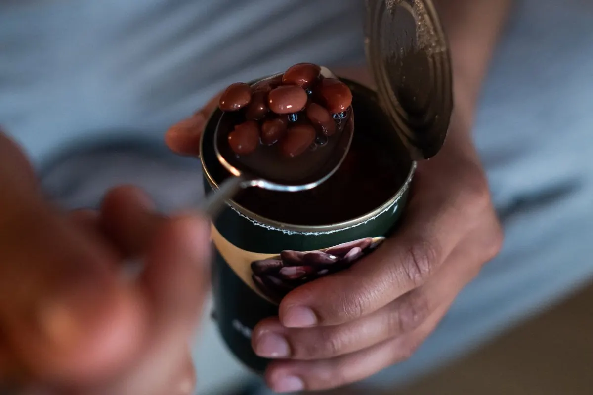 Canned red beans spooned from an open tin