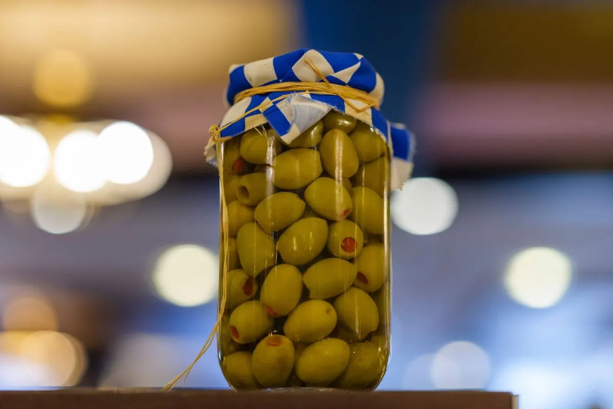 Jar of pimento stuffed green olives in brine