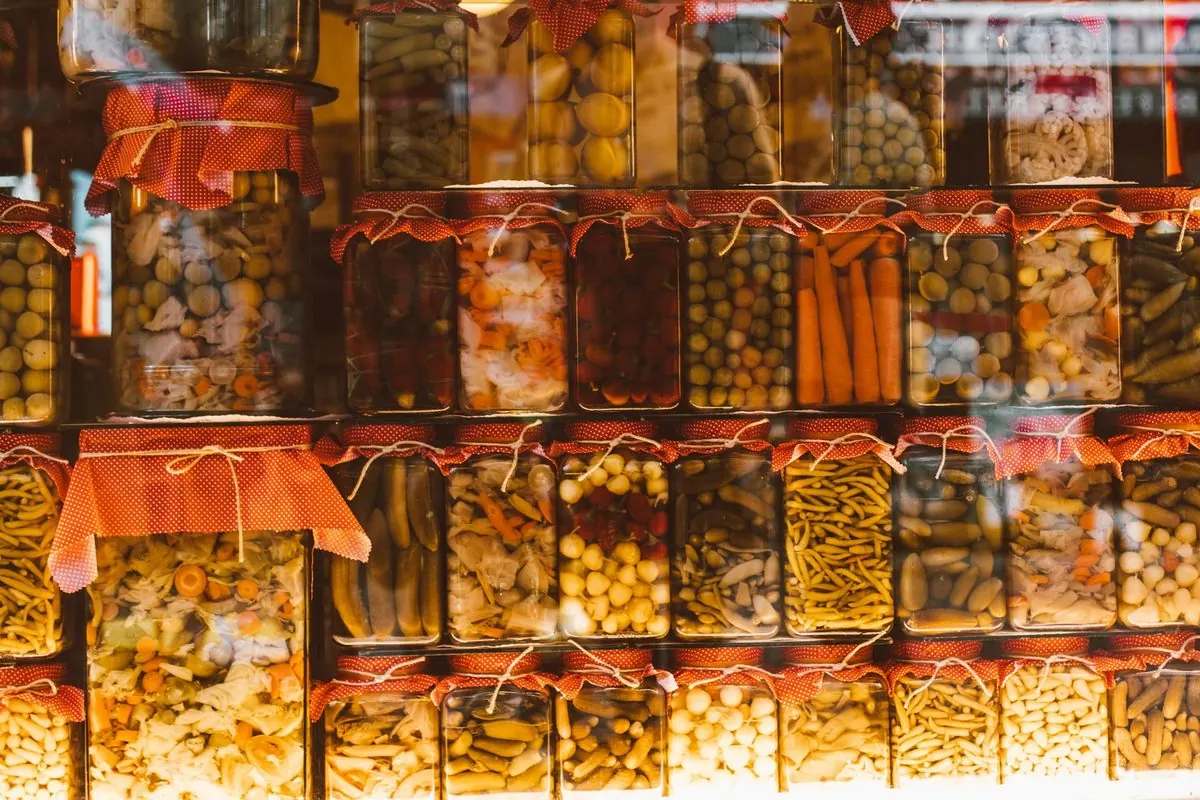 Shelves filled with glass jars of pickled and preserved vegetables