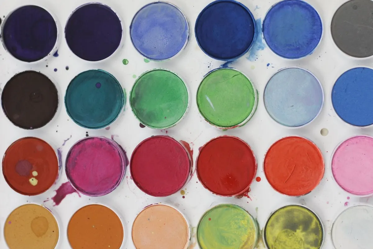 Watercolour paint set with round pans in blues, reds, oranges and yellows