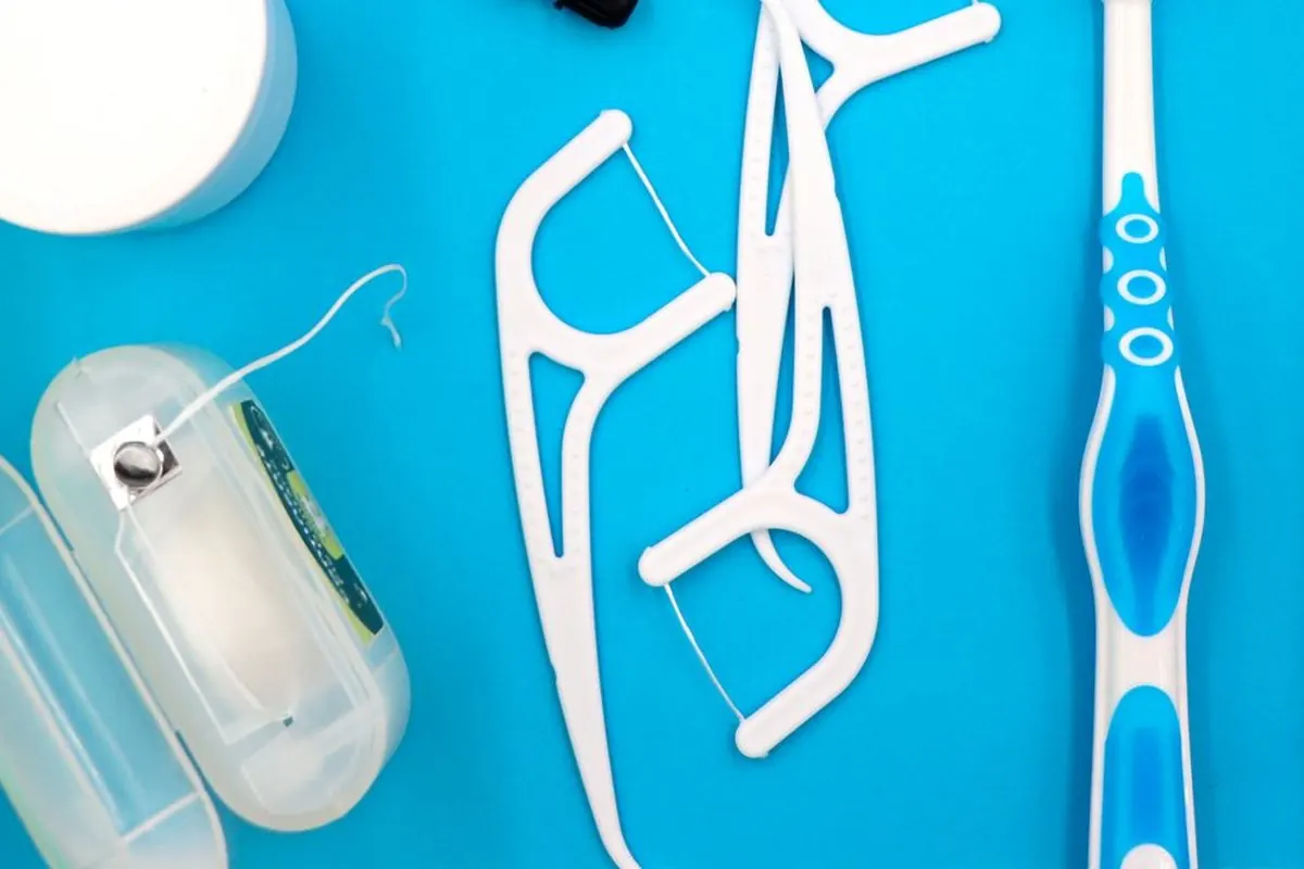 Dental floss dispenser and floss picks on a blue background