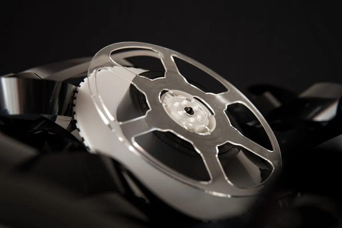 Cinema film reel on a pile of developed film