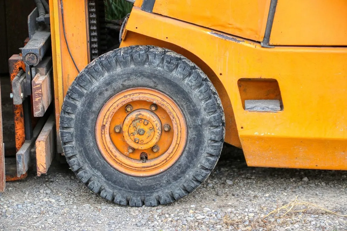 Black solid tyre on an orange forklift