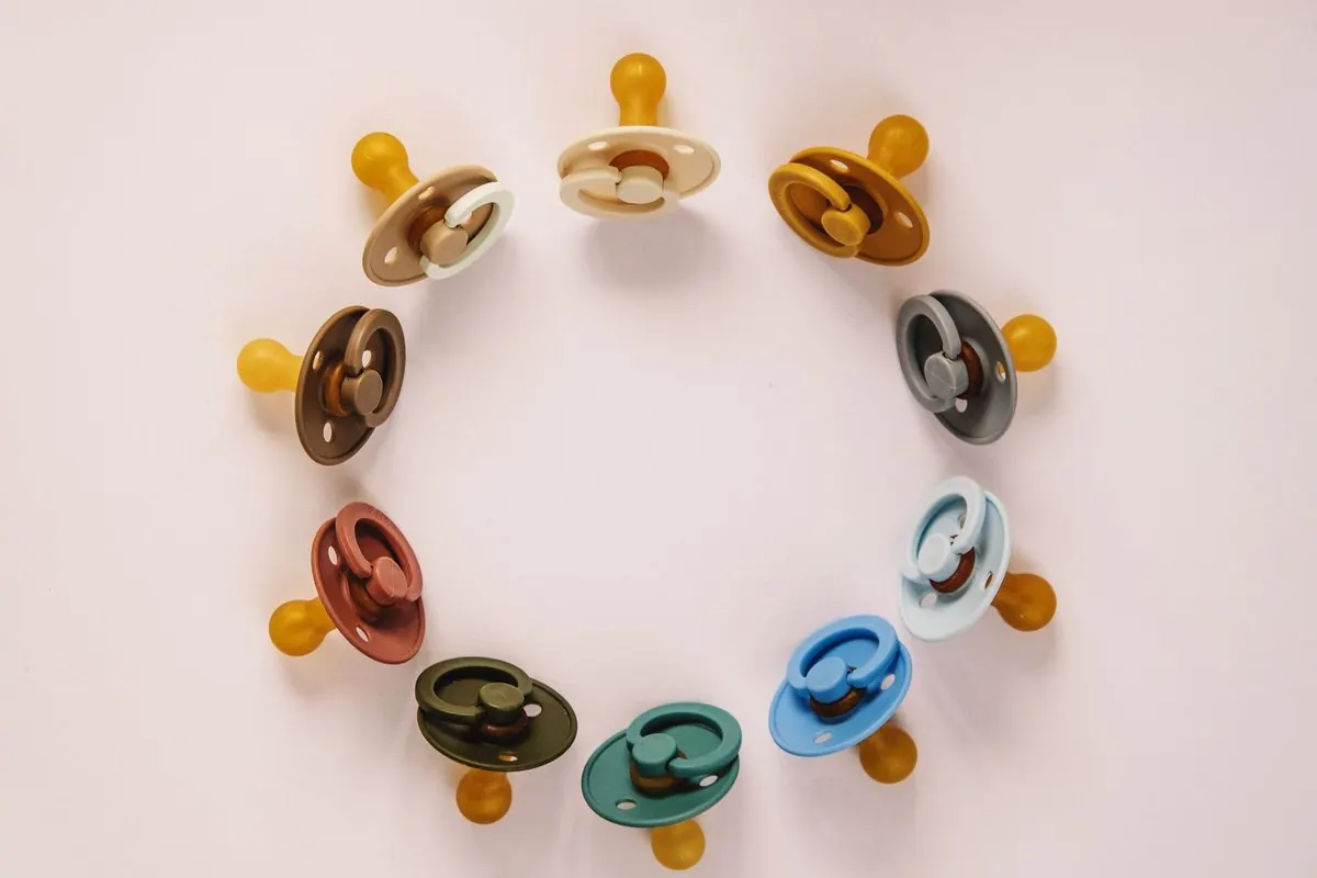 Baby pacifiers with rubber teats arranged in a circle