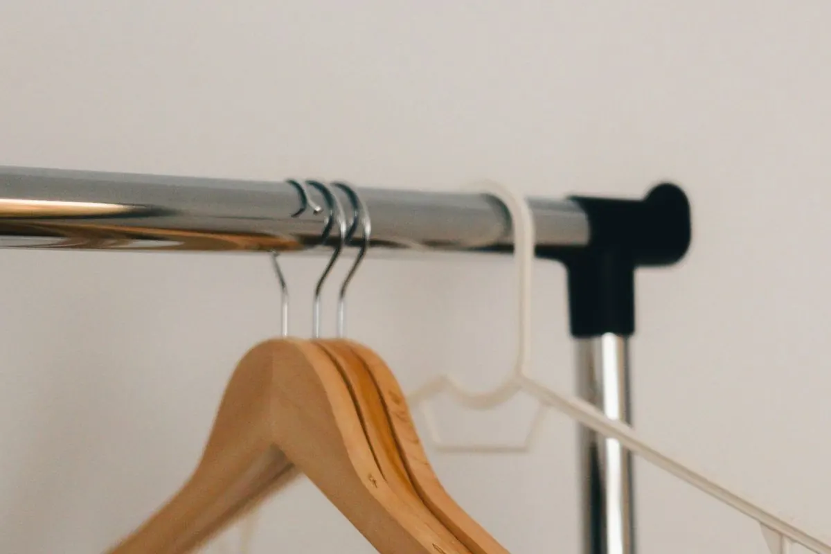 Wooden clothes hangers on a metal rail