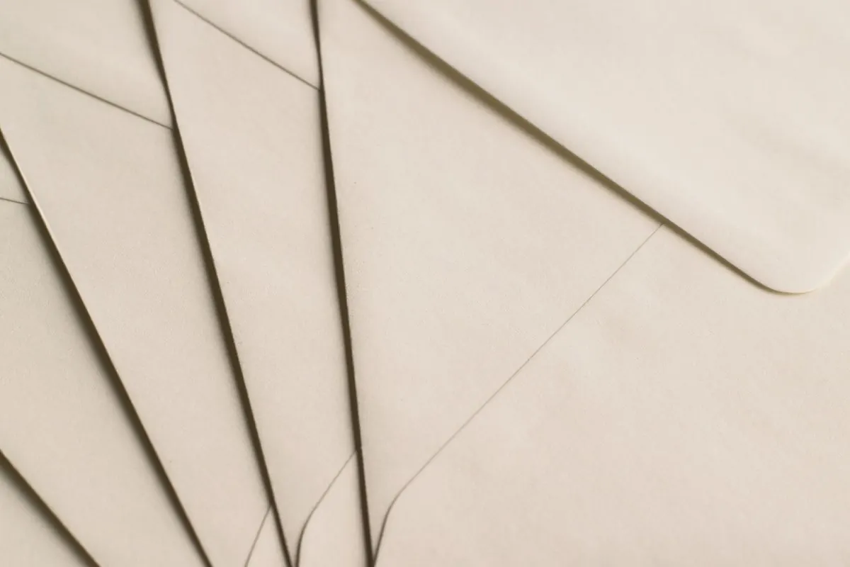 Cream paper envelopes fanned out in an overlapping stack