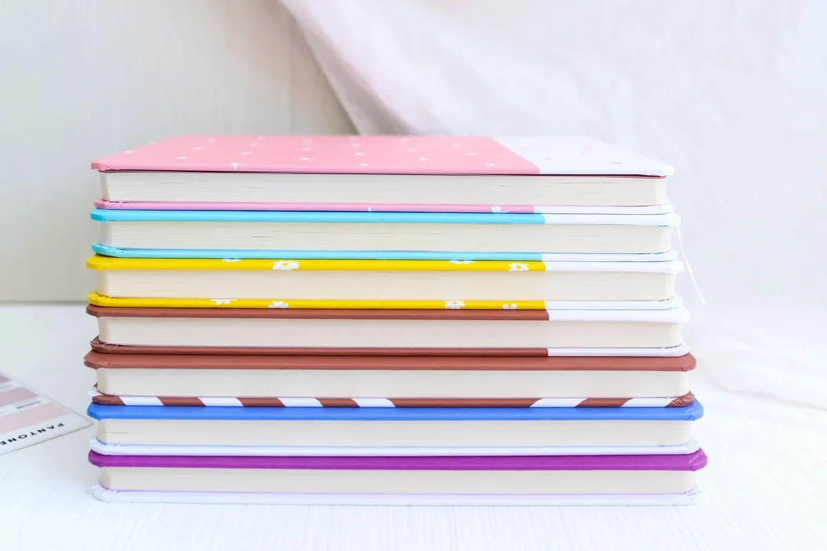 A neat stack of multicoloured hardcover notebooks