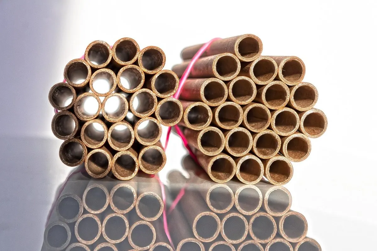 Bundles of brown paper tube cores lying side by side