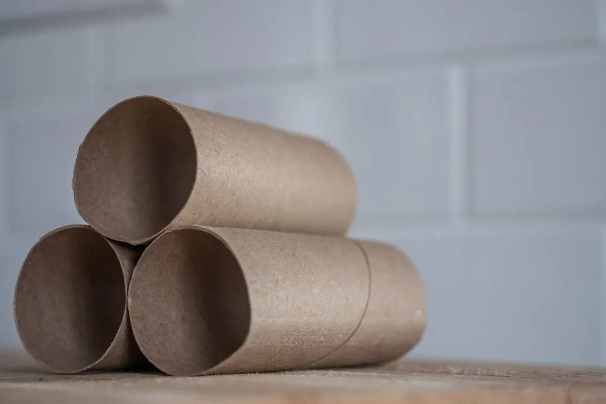 Three cardboard paper tubes stacked on a table