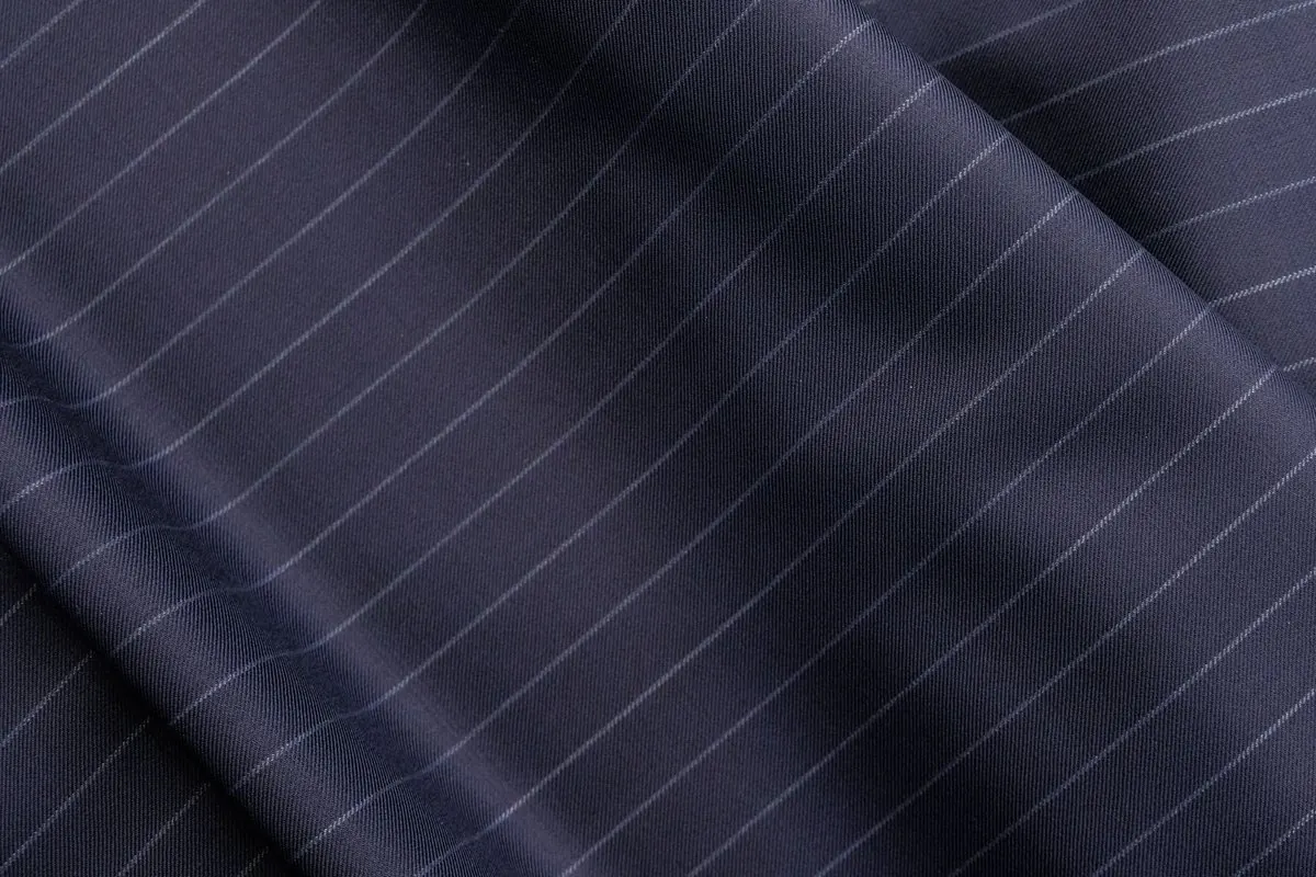 Navy pinstripe suiting fabric laid in folds