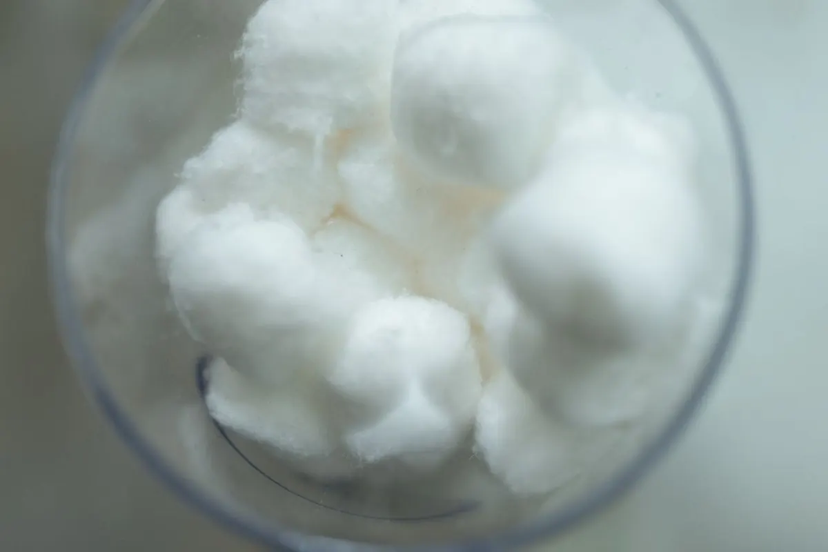 White cotton wool balls in a glass container