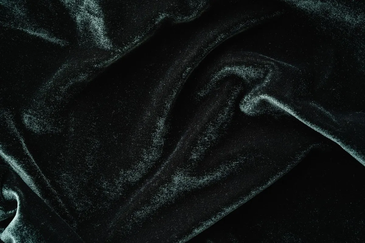 Close-up of black velvet with soft folds and sheen