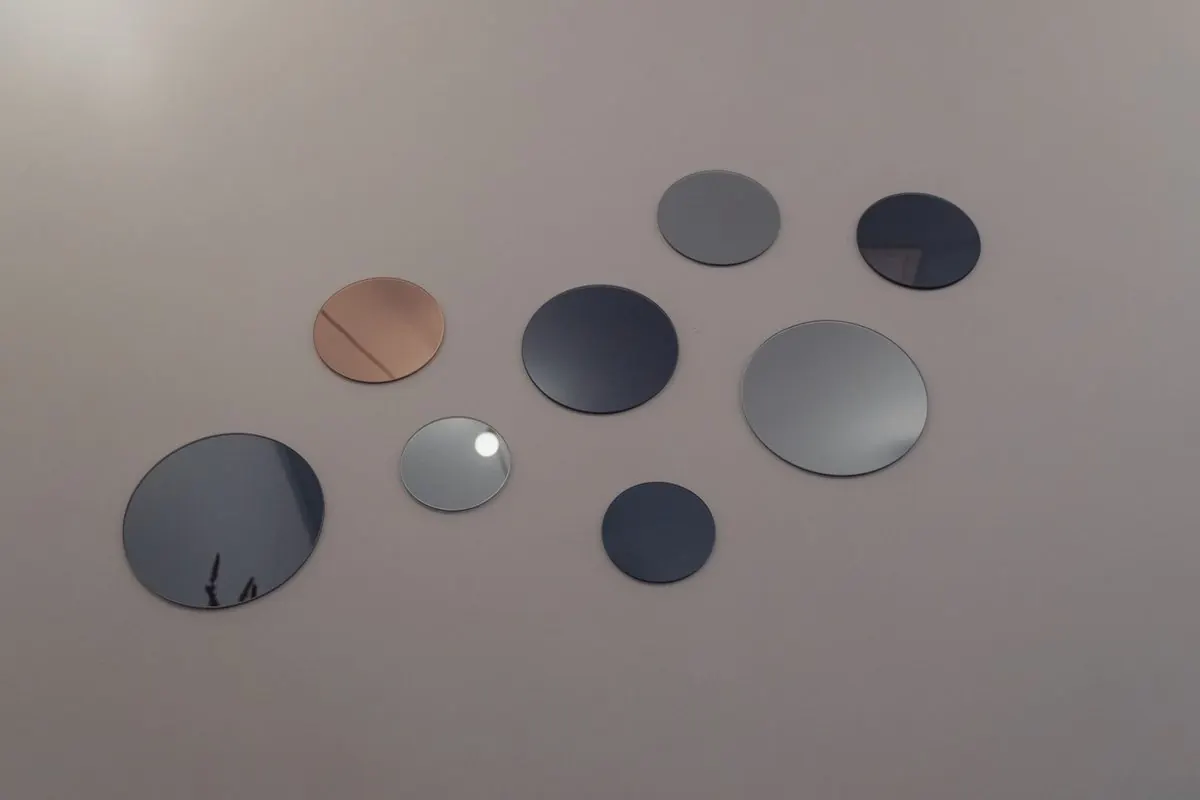 Frameless round mirrors on a wall