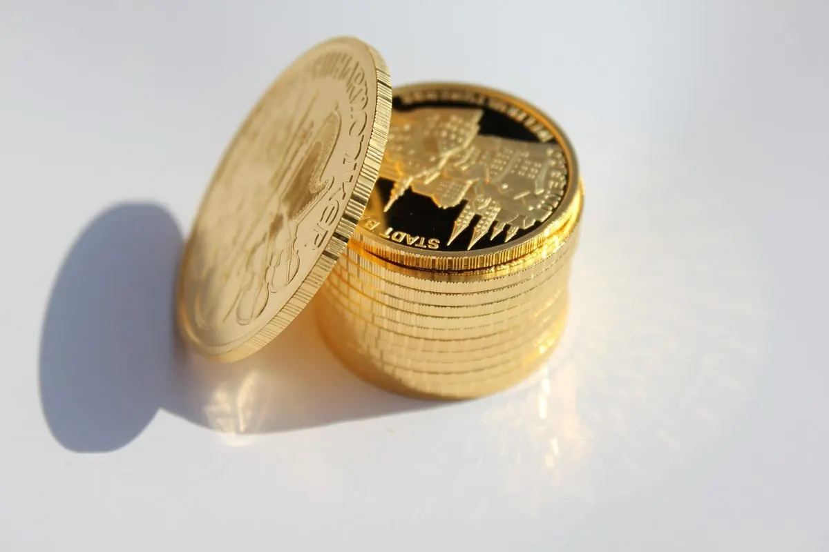 Stacks of gold coins on a white surface