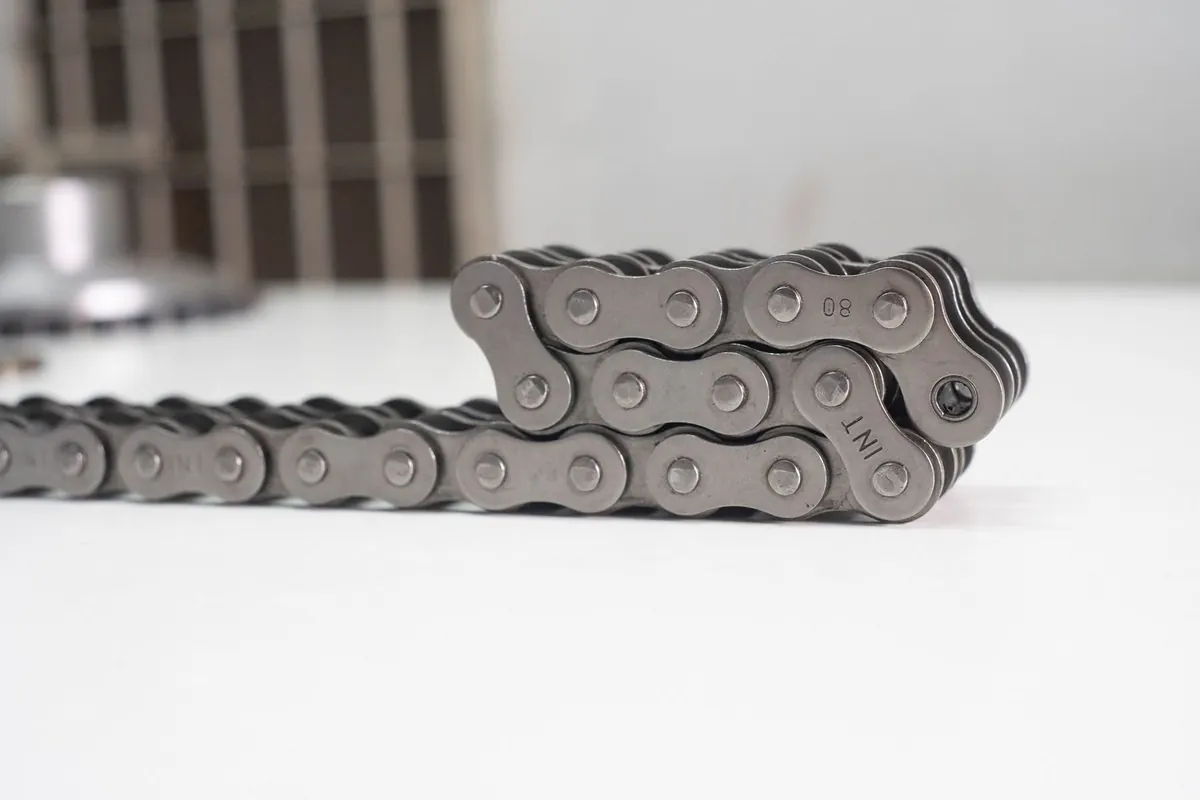 Length of grey roller chain on a white table