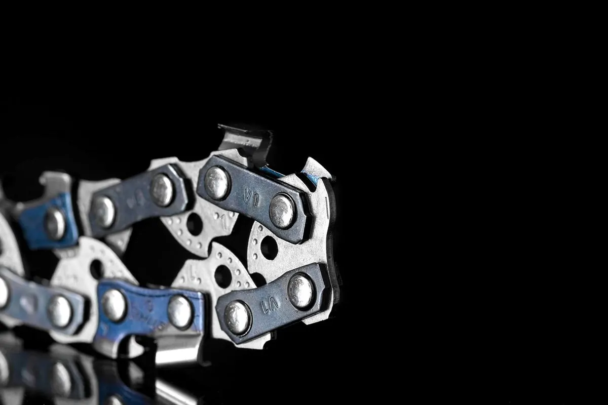Steel chainsaw chain on a black background