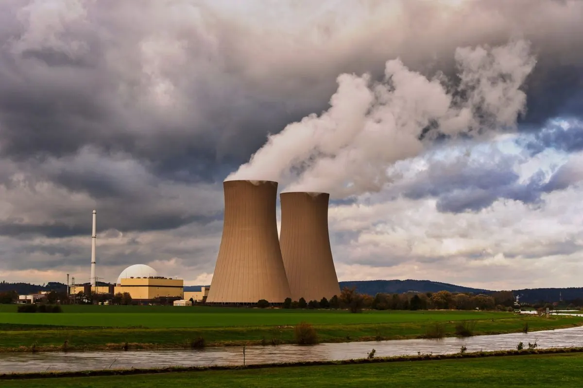 Nuclear power plant with cooling towers and white steam
