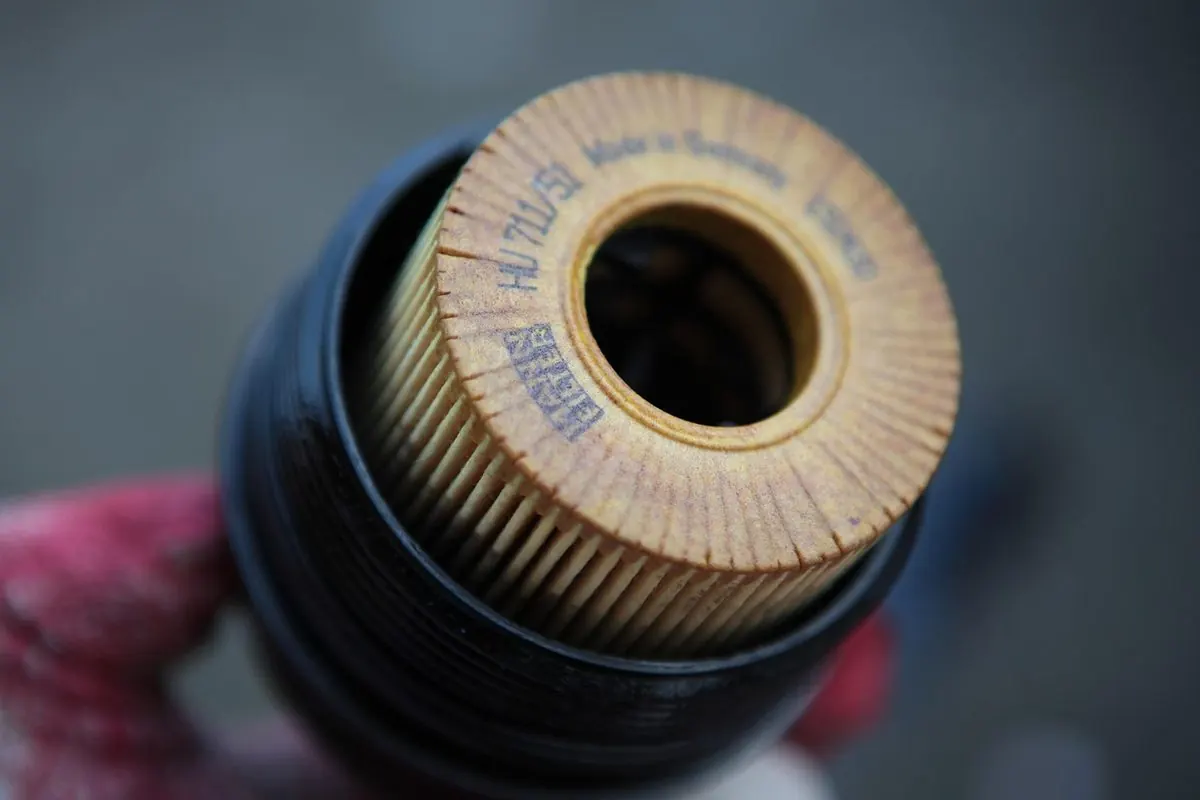 Hand holding an engine oil filter element