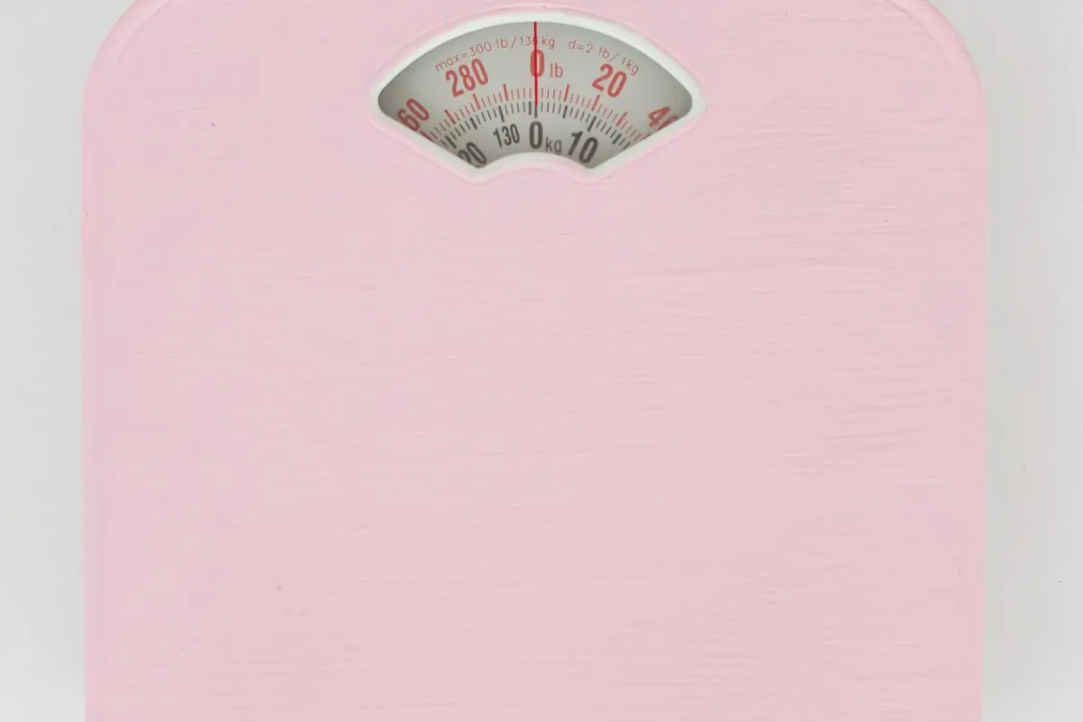 Pink bathroom scale on a white surface