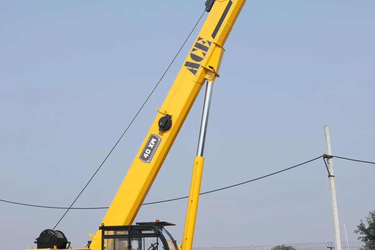 Yellow wheeled mobile crane with raised boom