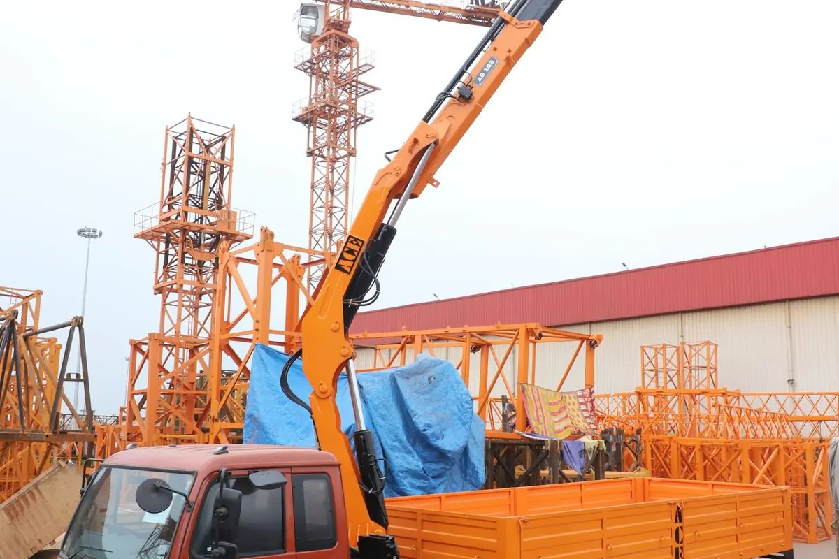 Orange truck with a folding loader crane