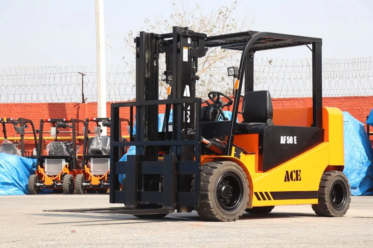Yellow-orange electric forklift in an outdoor yard
