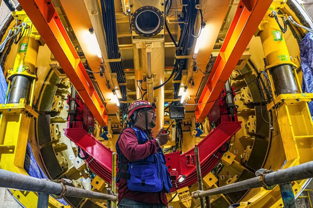 Engineer inside a yellow tunnel boring machine
