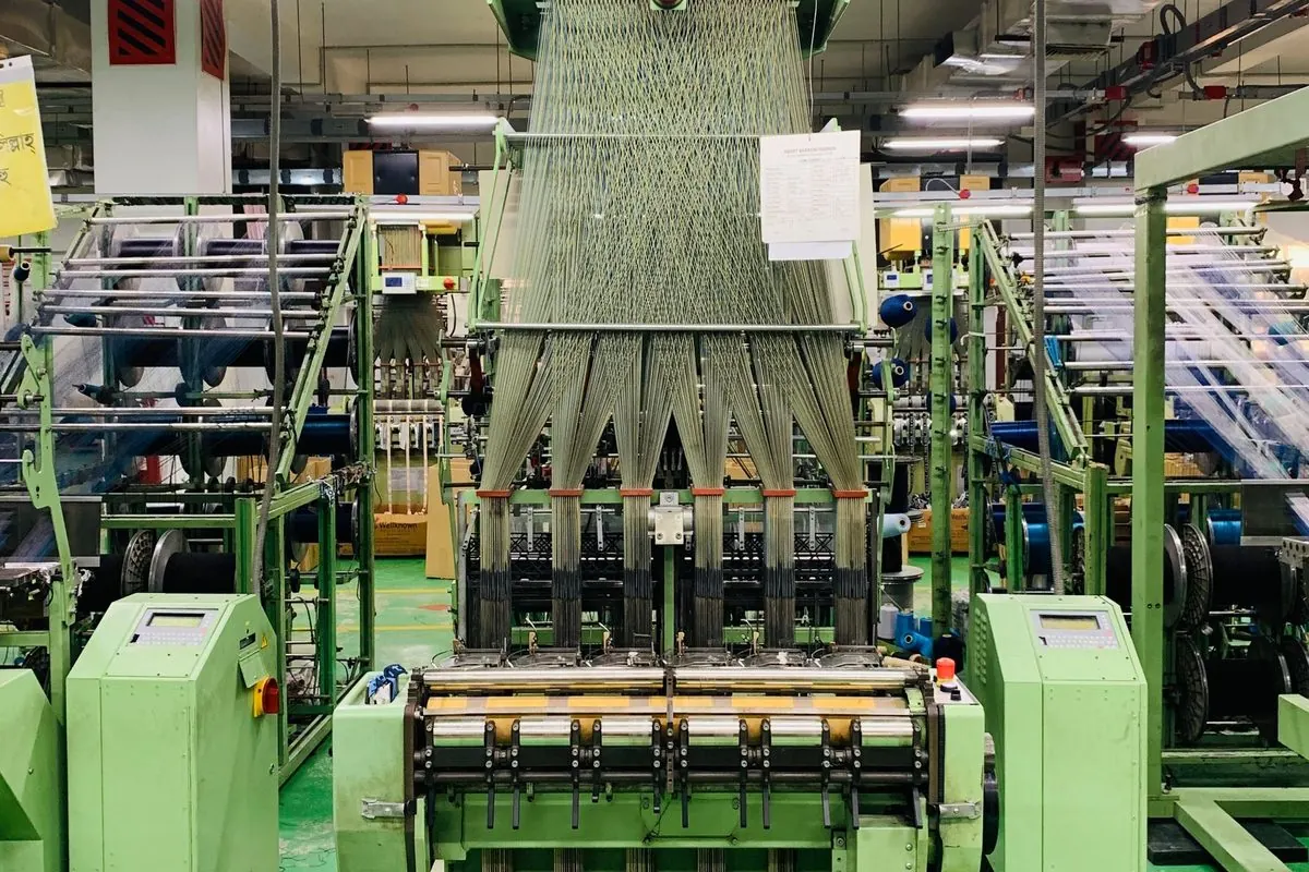 Green narrow fabric loom in a factory