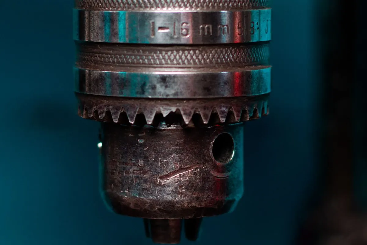 Old metal drill chuck mounted on a drilling machine