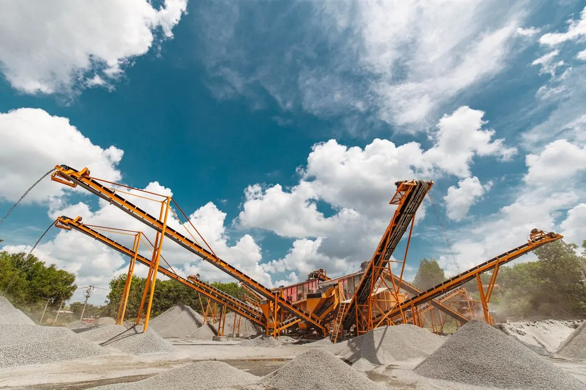 Orange conveyor screening line at a gravel quarry