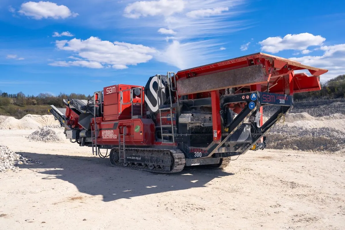 Red mobile rock crusher on a quarry yard