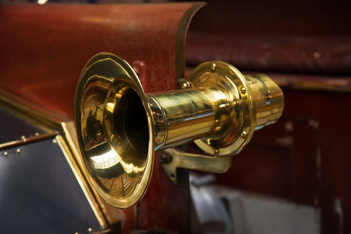 Old brass car horn mounted on a vehicle