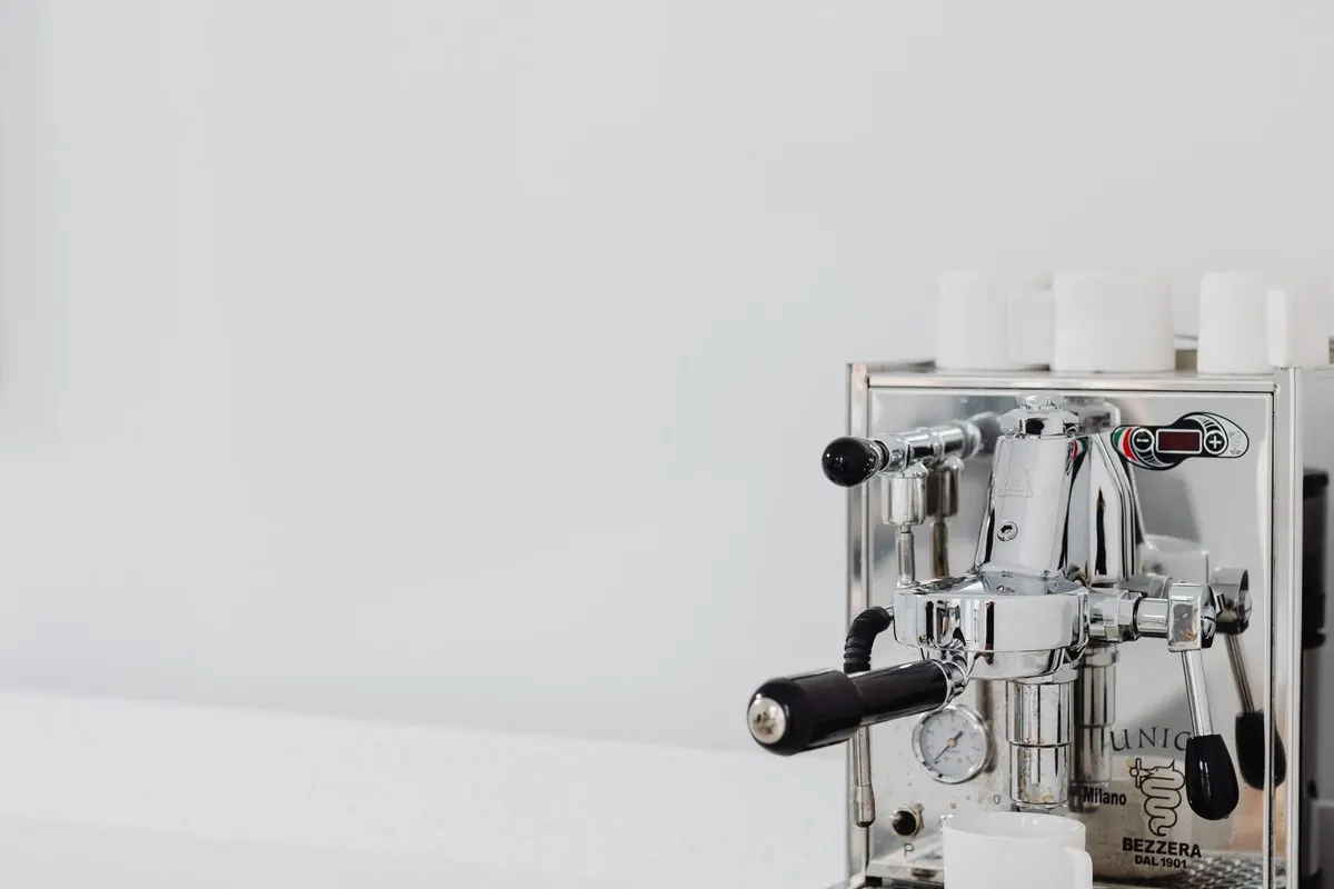 Stainless steel espresso machine on a white kitchen counter