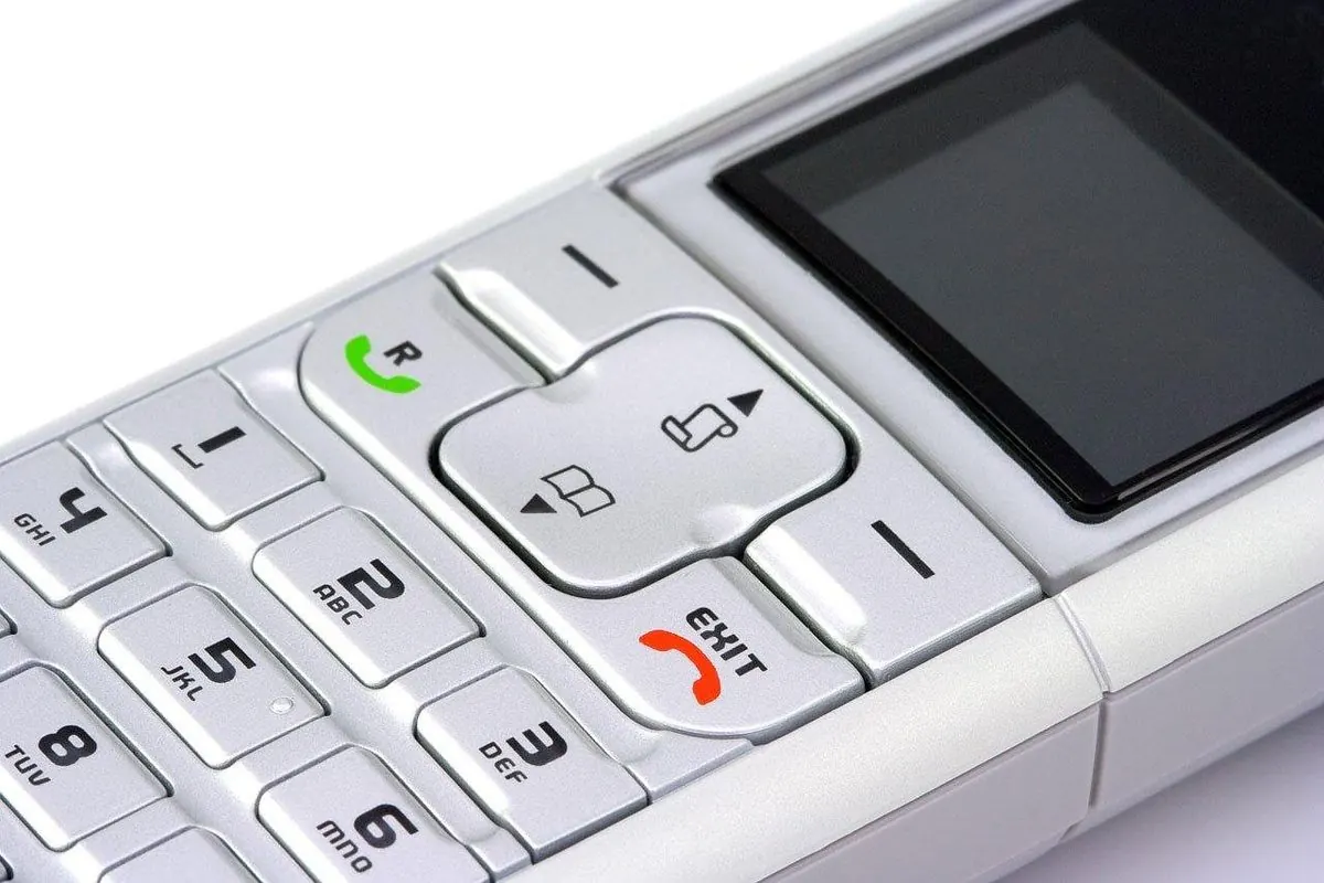 Close-up of a cordless landline phone with keypad and screen