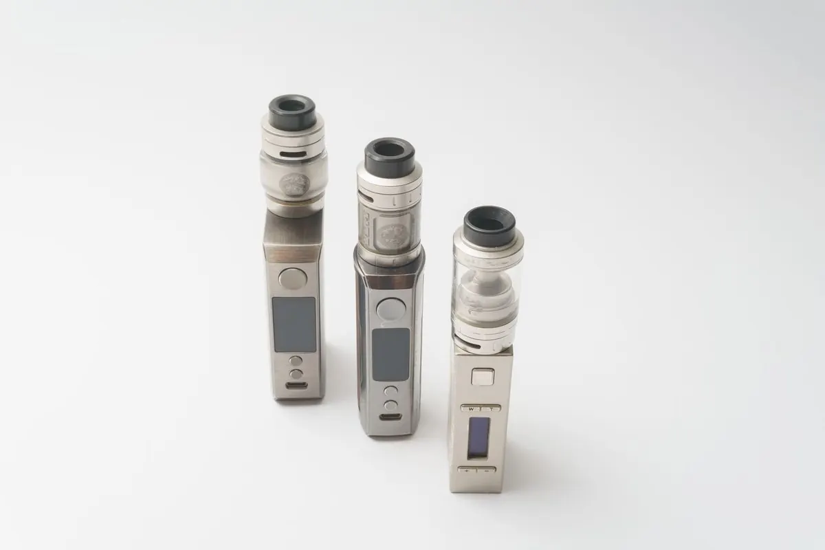 Three metal personal vaporizers on a white background