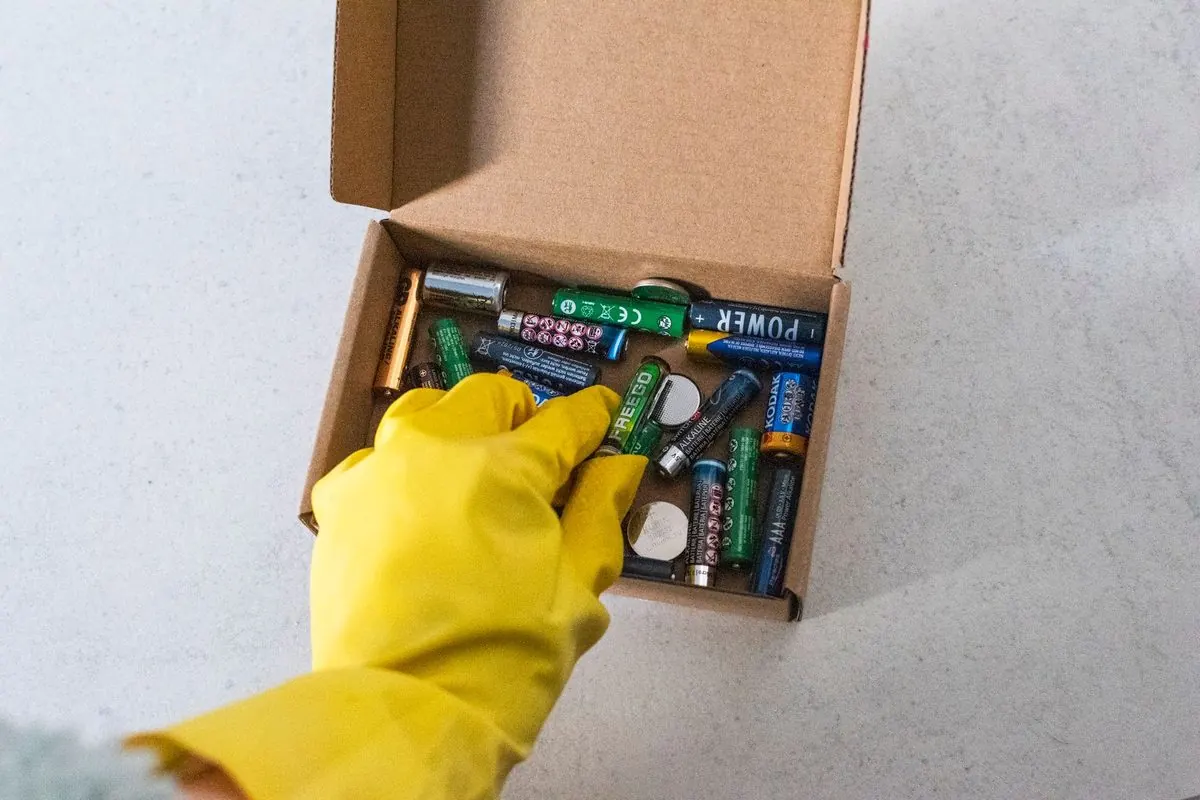 Used batteries collected in a cardboard box