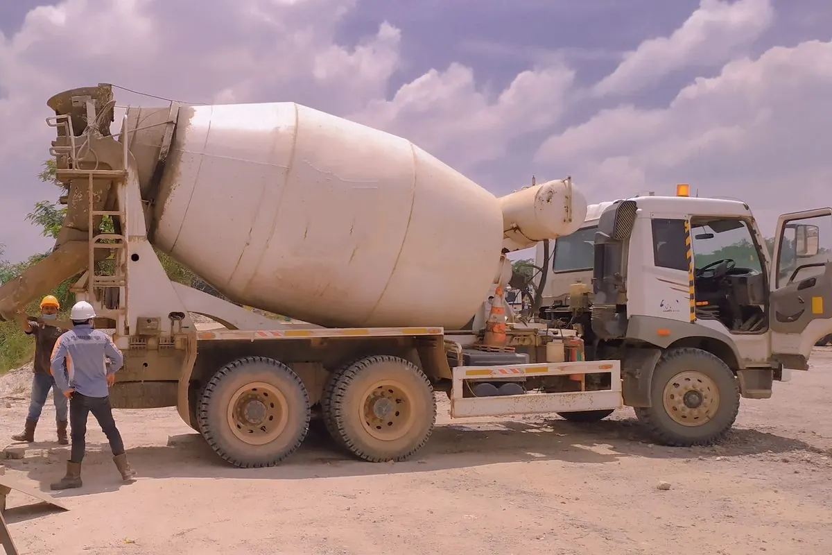 White concrete mixer truck on a construction site