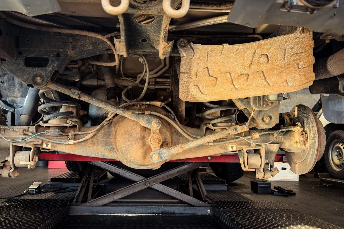 Axle and suspension under a car on a lift