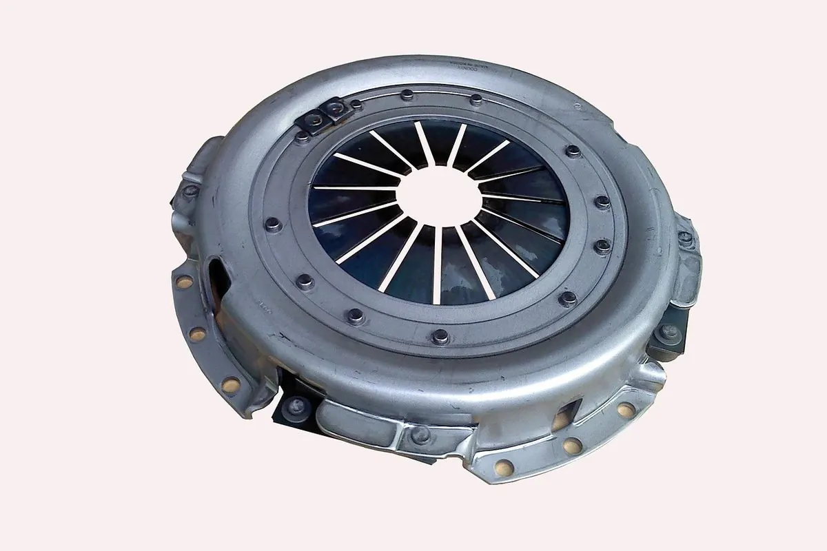 Metal car clutch assembly on a pale pink background