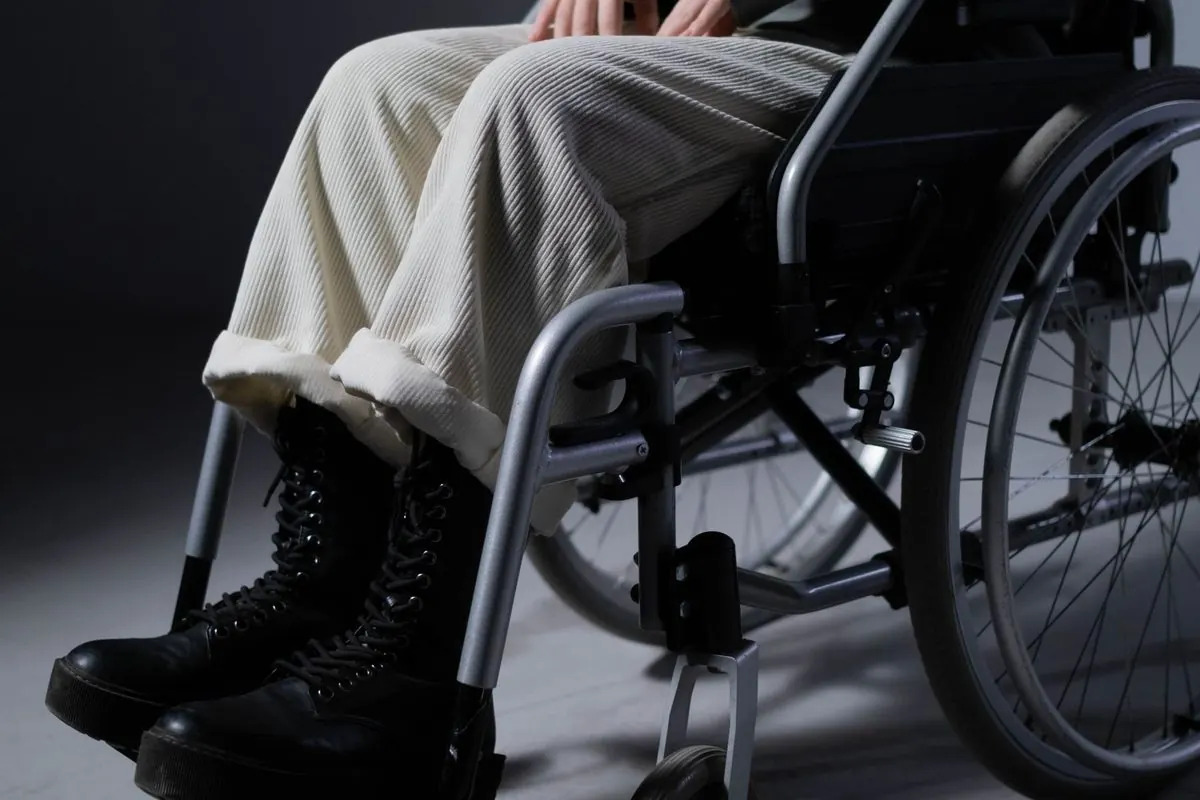 Manual metal-frame wheelchair with a seated person