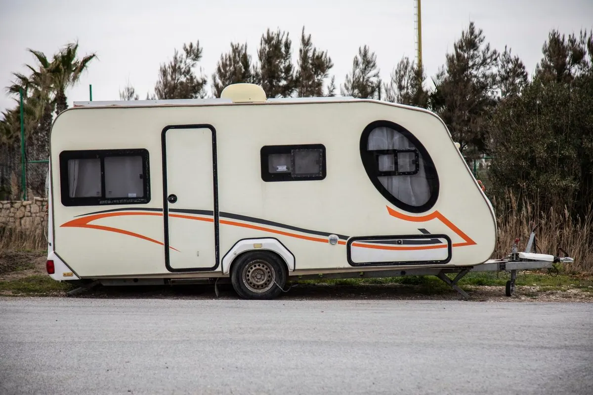 White travel trailer parked on a road