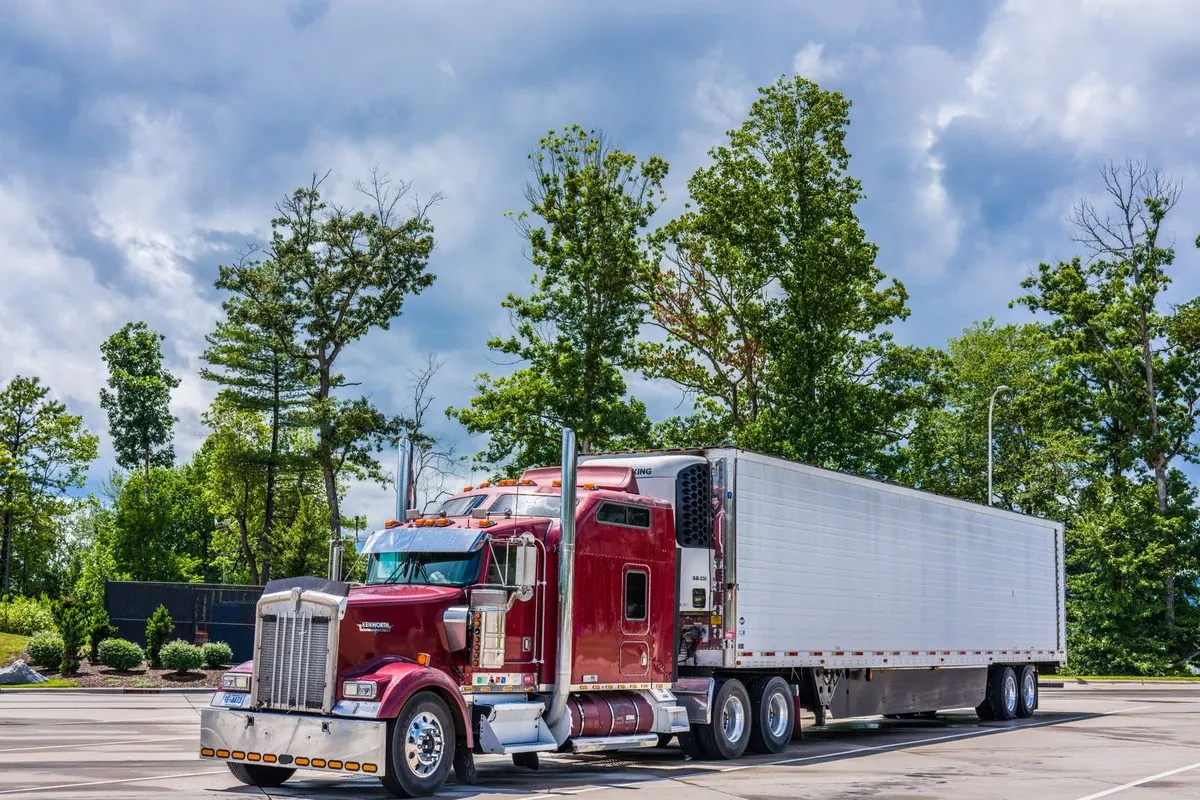 Red tractor unit pulling a cargo semi-trailer