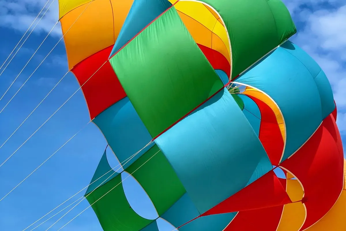 Colorful open parachute against a blue sky
