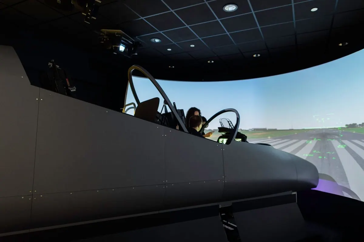 Flight simulator room with cockpit and curved screen