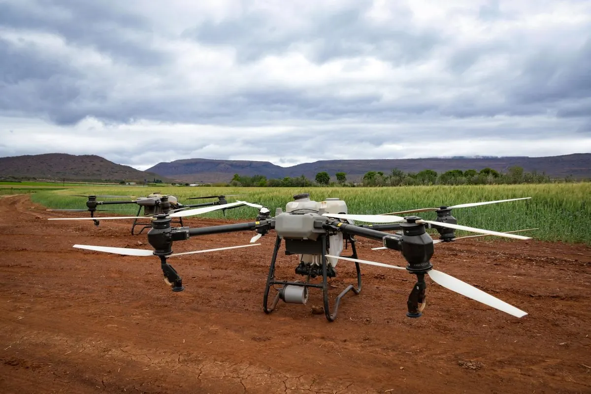 Large agricultural drone landing on a field
