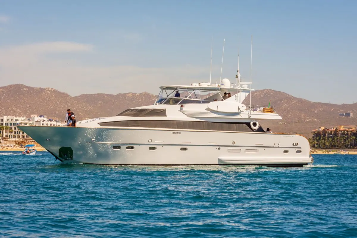 White motor yacht cruising near the coast
