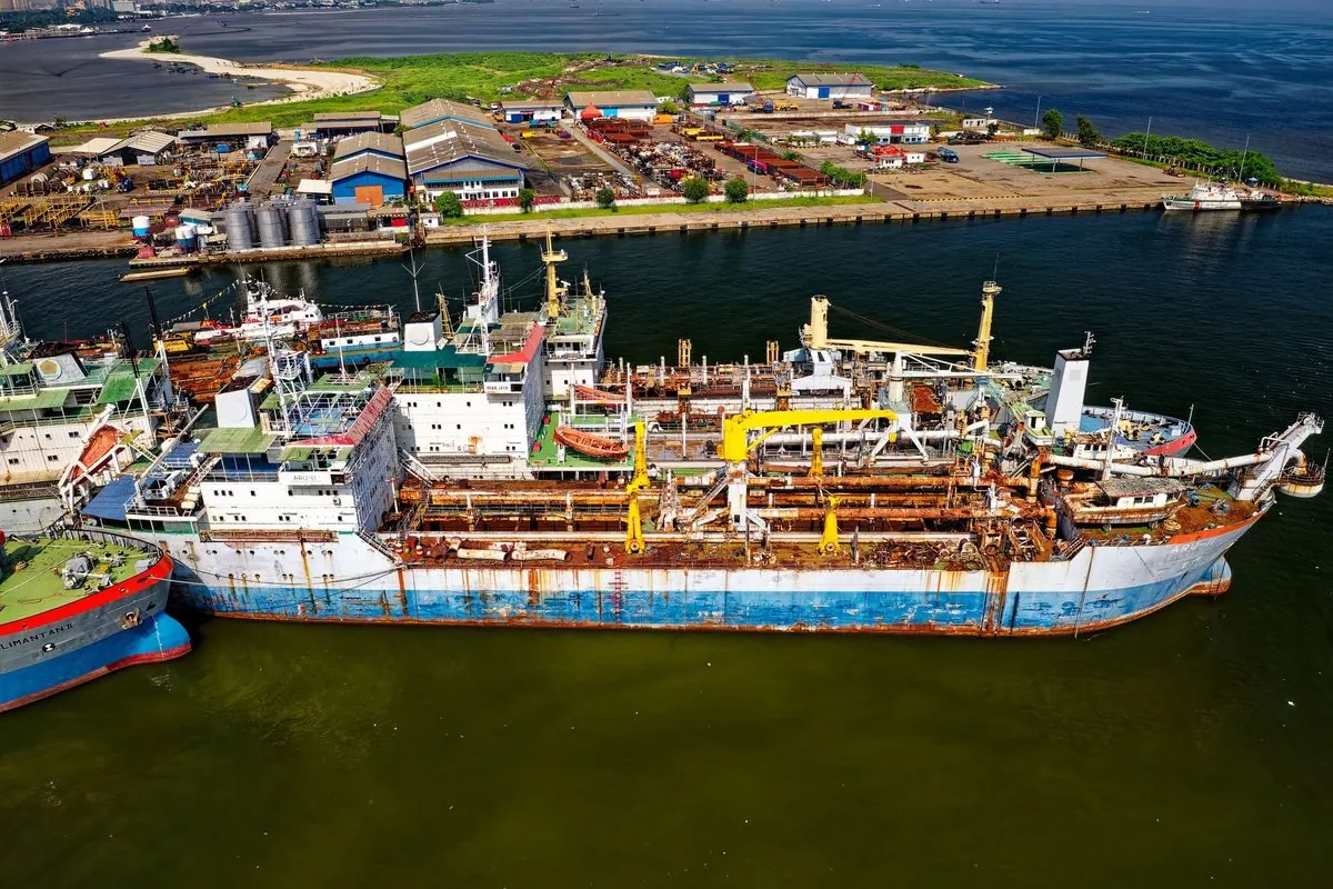 Aerial view of old rusty ships at a breaking yard