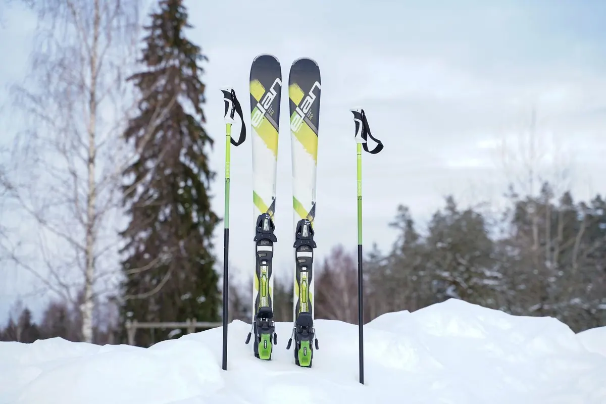 Pair of skis and poles standing in snow