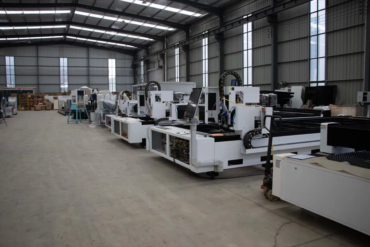Row of new laser cutters and CNC machines in a factory hall